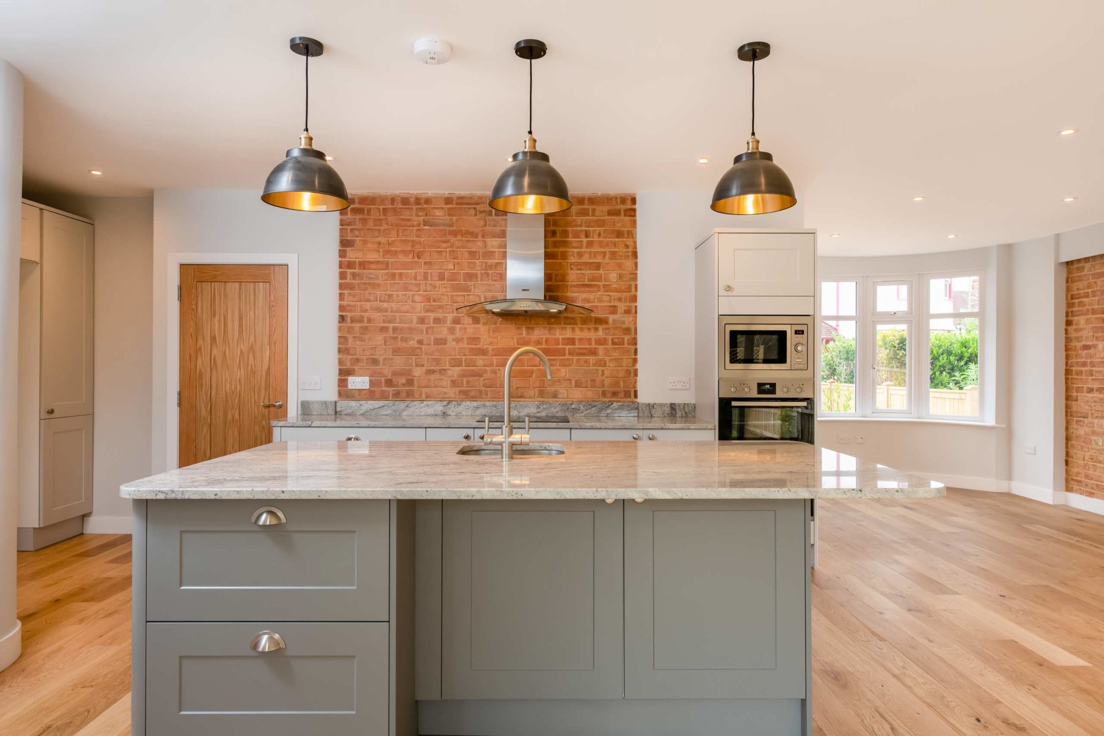 View of the kitchen and living space showing the front bay windows in the Tiermana new build project