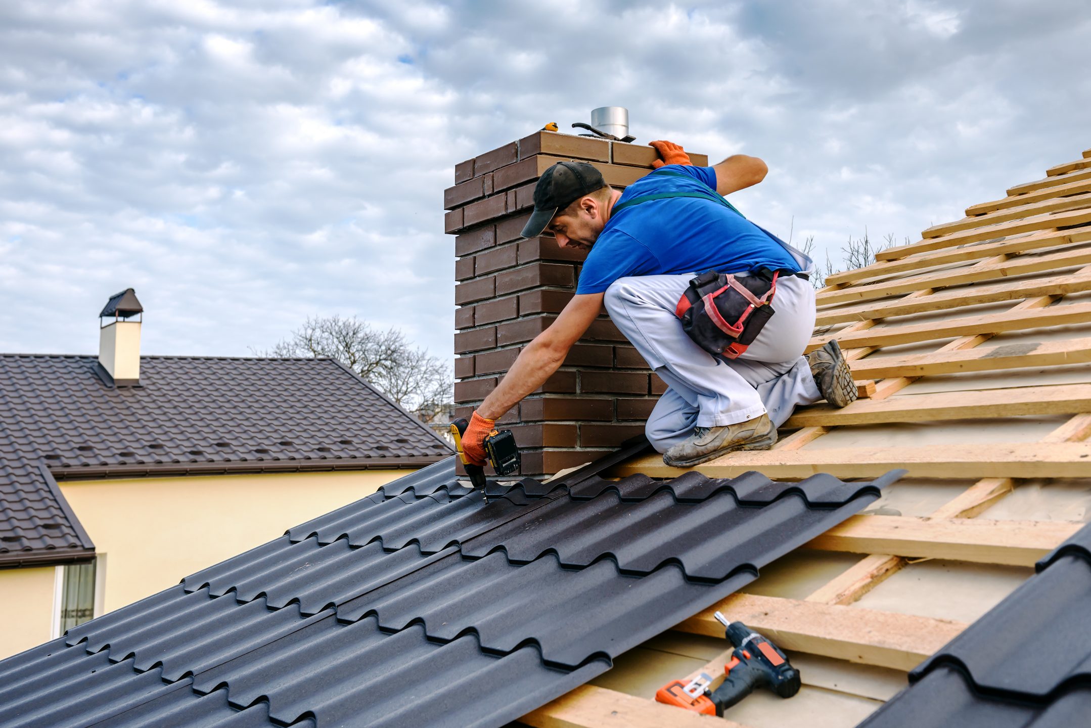 A roofer attaching Tiles to a new roof