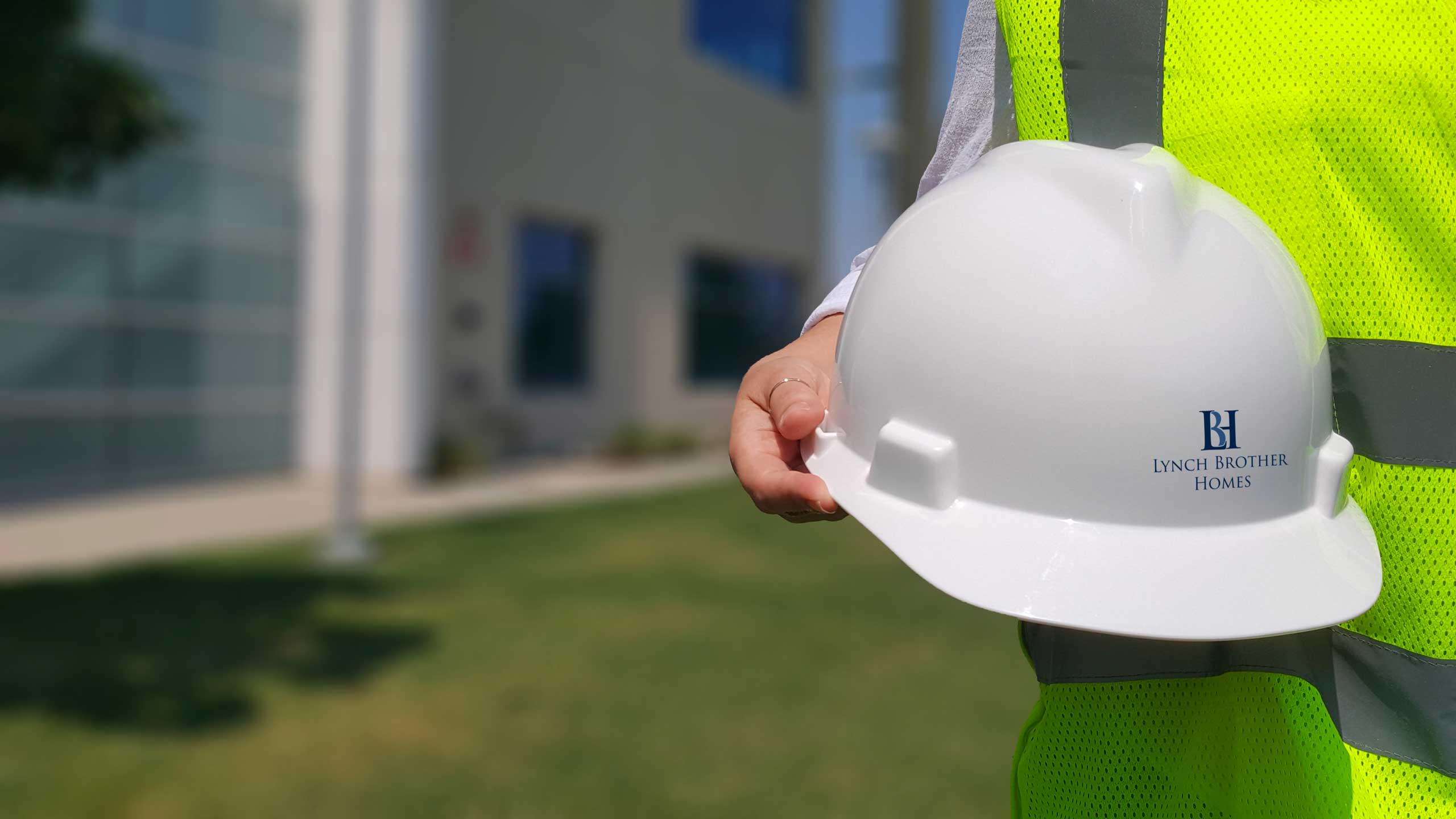 hardhat with Lynch Brother logo being held